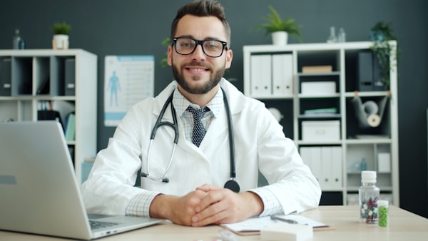 Professional doctor at desk with stethoscope